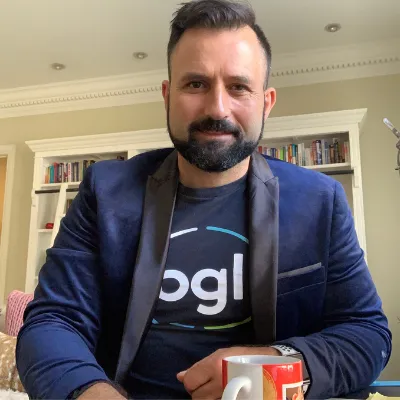 Daniel Tramontana of BGL Corporate Solutions at home in a BGL T-shirt with a coffee mug