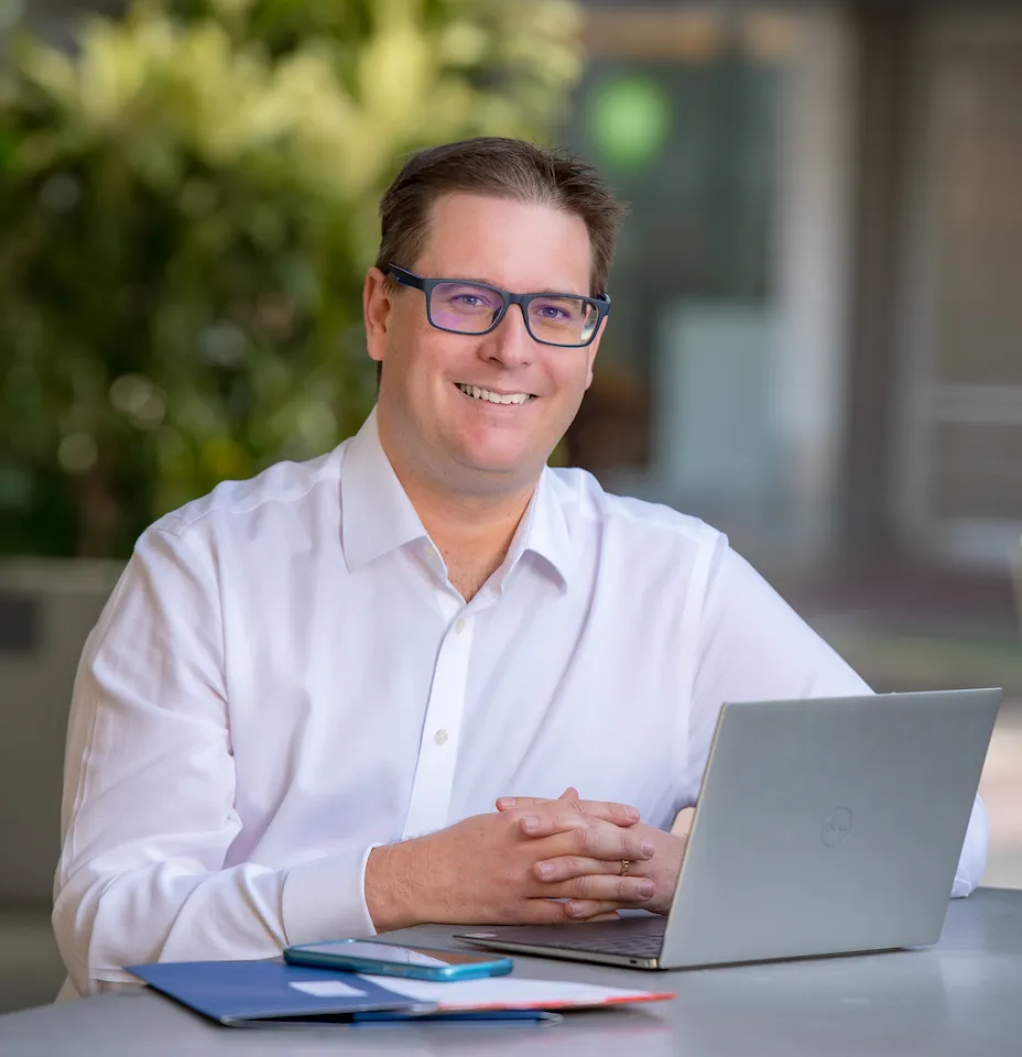 A JTW Accountants portrait of an accountant in a white shirt, seated at a laptop